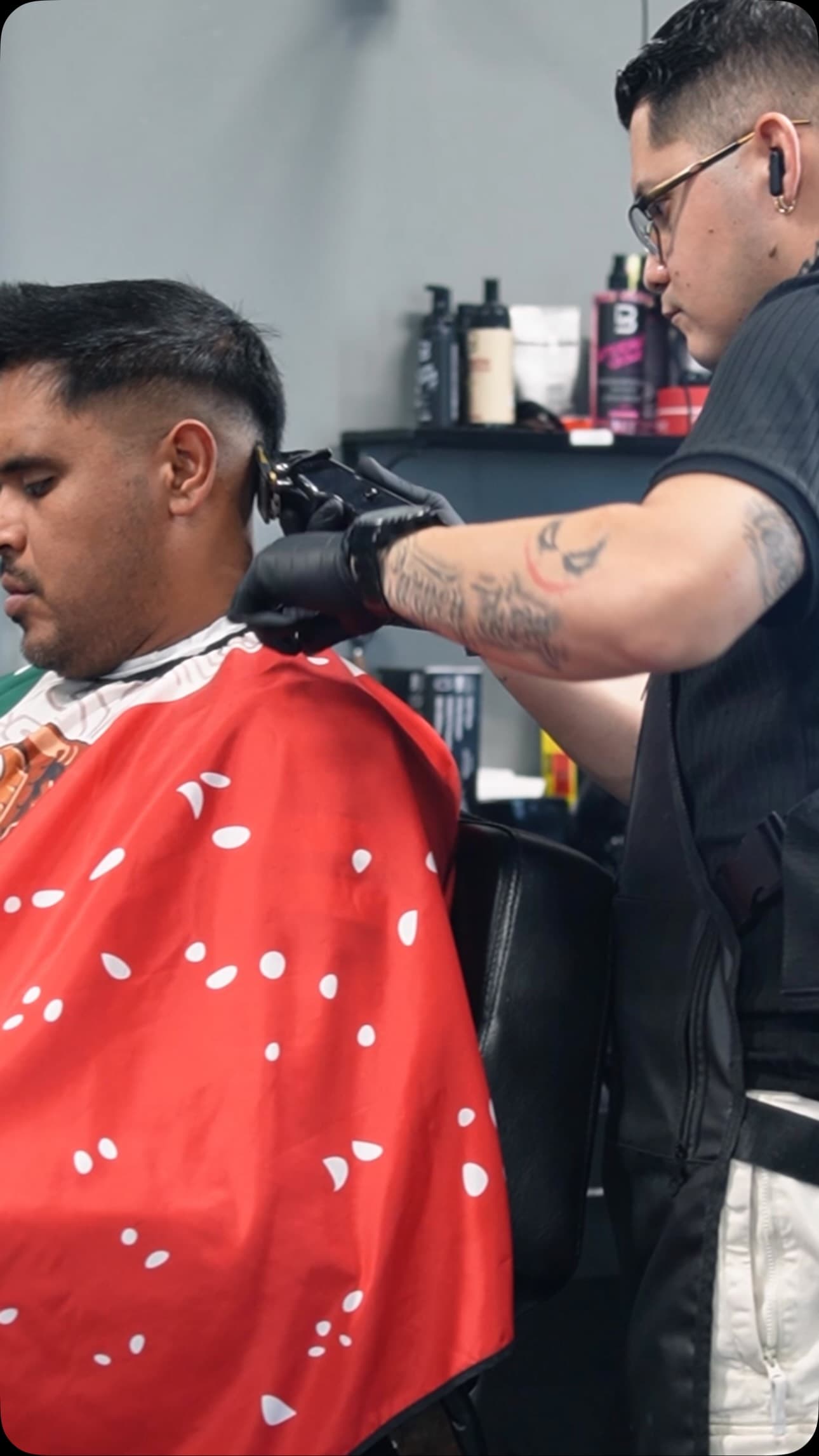 A Cali Cuts Studio barber giving a client a fade